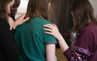 A woman is being comforted during a difficult time